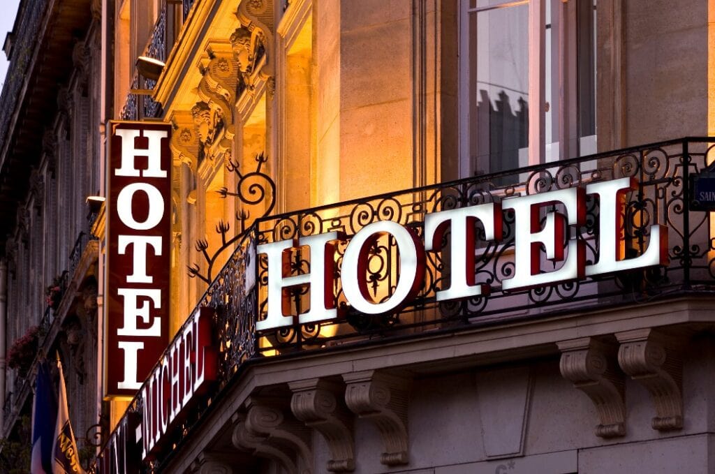 Illuminated Parisian hotel sign taken at dusk